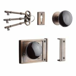Signature Hardware Horizontal Brass Rim Lock Set with Black Porcelain Knobs Left Hand in Antique Brass